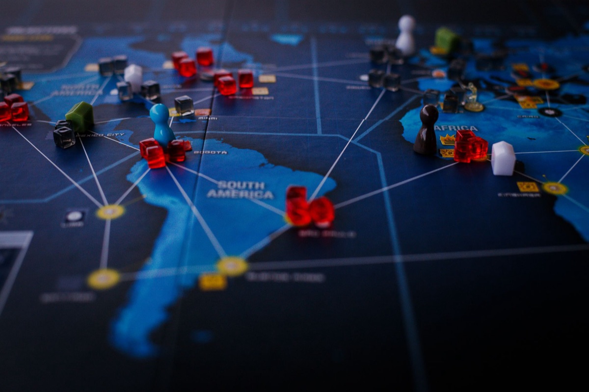 A strategic board game featuring a world map and colorful playing pieces.