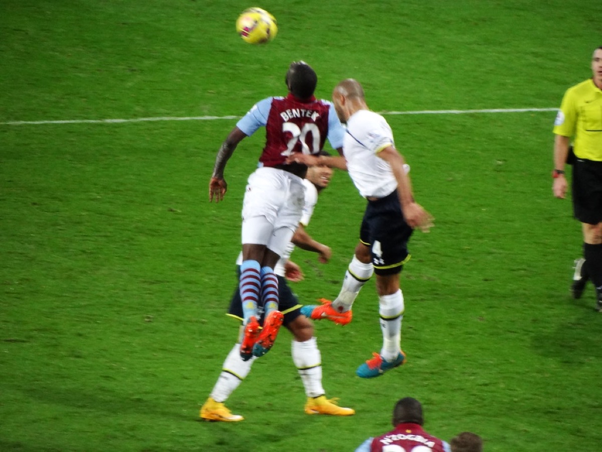 Aston Villa striker Christian Benteke and Tottenham Hotspur defender Younis Kaboul leap for the ball at a corner