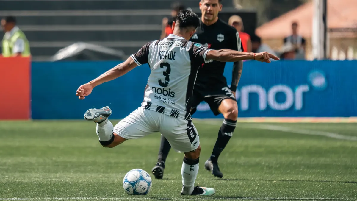 Exciting close-up of a soccer player kicking the ball during a match.