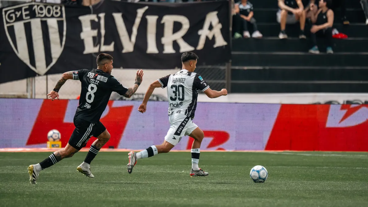 Dynamic soccer game showcasing players in action on the field with an enthusiastic crowd in the background.