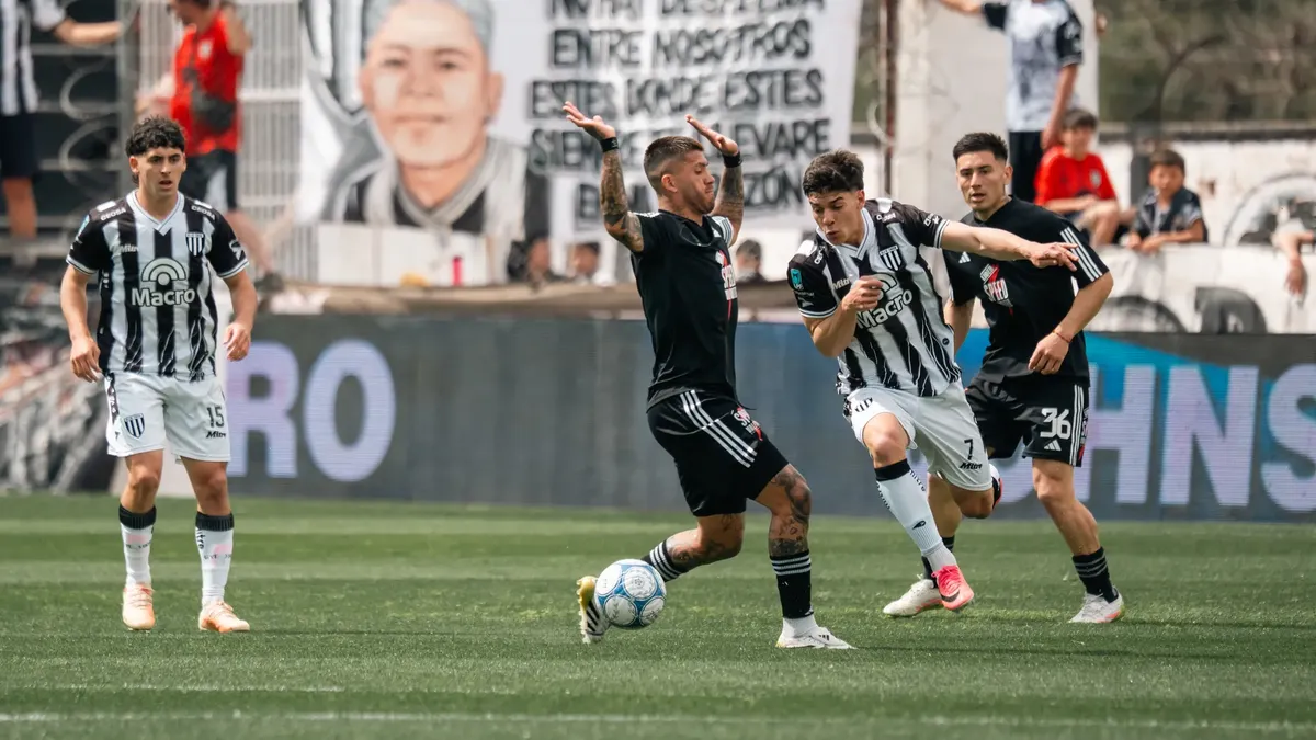Players in action during a competitive soccer match on a grassy field.